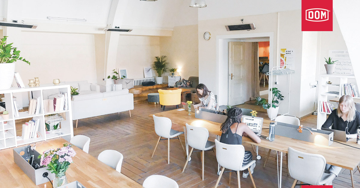 an empty coworking space with three women working apart